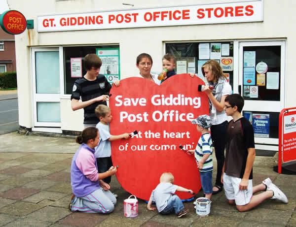 A giant red heart has been erected outside Great Gidding Shop and Post Office urging "Save our Post Office.