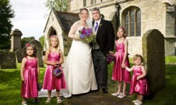 Laura and Mads with their bridesmaids in front of St Michael's Curch, Great Gidding