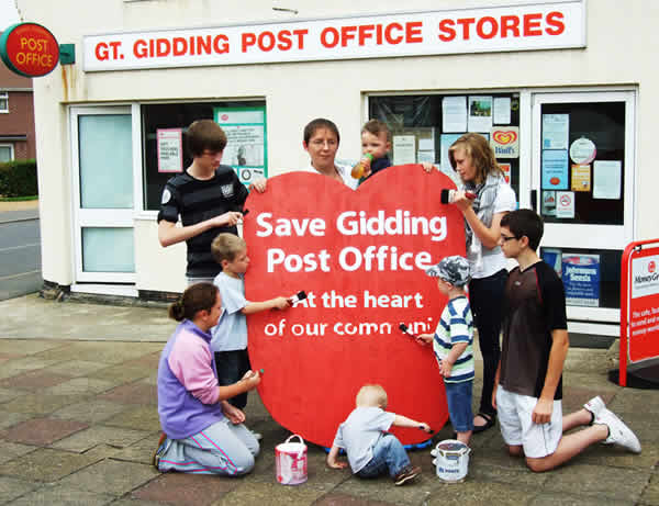 A giant red heart has been erected outside Great Gidding Shop and Post Office urging "Save our Post Office.